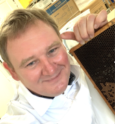 Picture of Dr Ryabov holding a bee frame